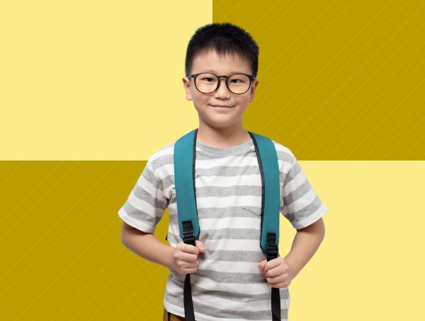 A smiling child wearing a backpack