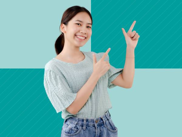 A smiling women pointing her fingers to the sky. 