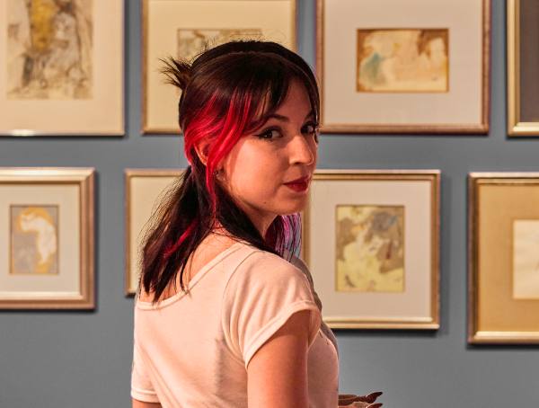 A woman admires a gallery wall