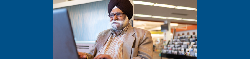 A person explores resources for new Canadians at the library.