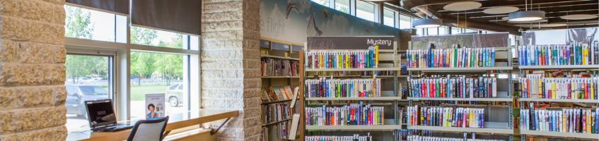 Shelves full of books and a sitting area from inside Prince of Wales Branch.
